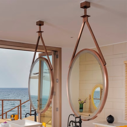 Hanging rose gold metal rimmed vanity mirror