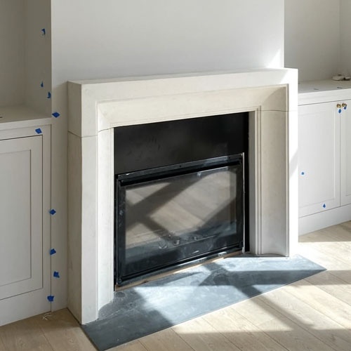 Residence modern fireplace surround in honed turkish limestone