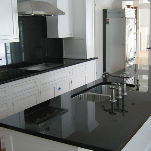 absolute black granite countertop and white shaker kitchen cabinet