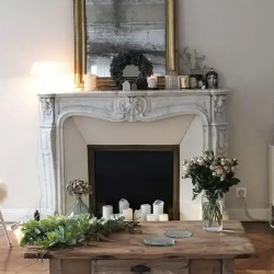 A beautiful living room with a French fireplace