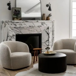 A chic contemporary nook with a white marble fireplace