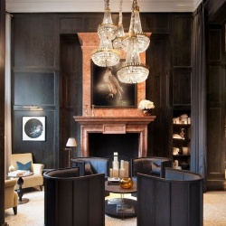 A lobby fireplace in an arched marble