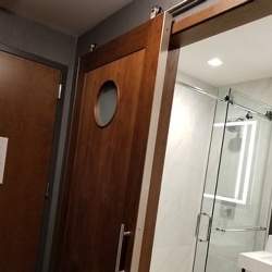 Bathroom barn door with Round Lite Four Points by Sheraton