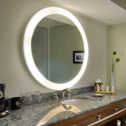 Bathroom vanity with granite countertop and round lighted mirror