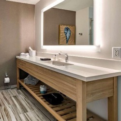 Bathroom wood vanity base and quartz top in Cambria Hotel