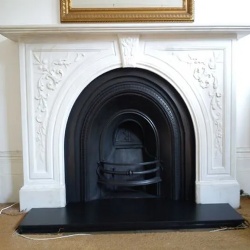 Carved statuary spandrel mantel piece