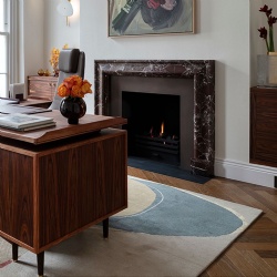 Contemporary fireplace mantel carved from marble Rosso Levanto