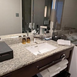 Custom granite hotel vanity with backsplash