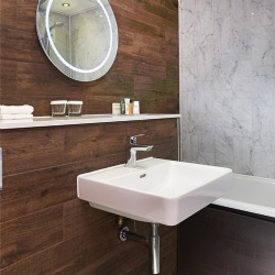 Floating porcelain lavatory fixture for accessible bathroom