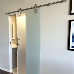 Frameless sliding frosted glass barn door with privacy lock