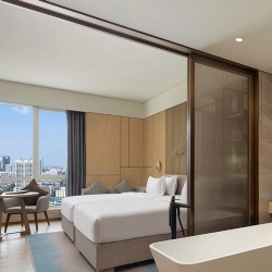 Hotel room moving partition by fabric laminated glass