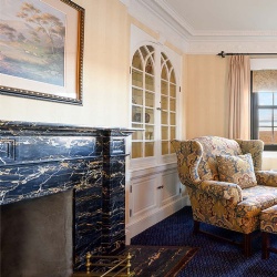 Portoro Gold marble fireplace mantel for hotel fireplace room