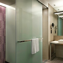 Rolling Glass Door and Fixed Partitiion in Aloft Hotel Bathroom