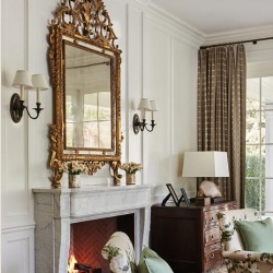 gold leaf baroque mirror over white marble fireplace mantel