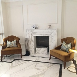 white marble fireplace mantel for boutique hotel lobby