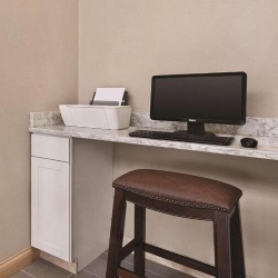 working station with wood cabinet and marble countertop